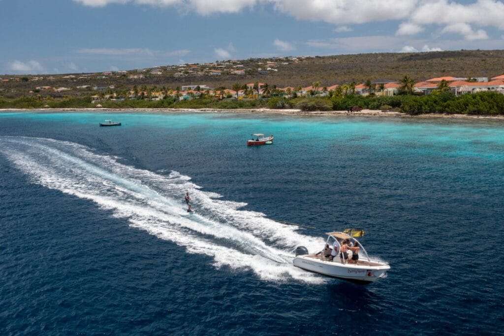 Boat with water skier on the deep-blue water at Bonaire